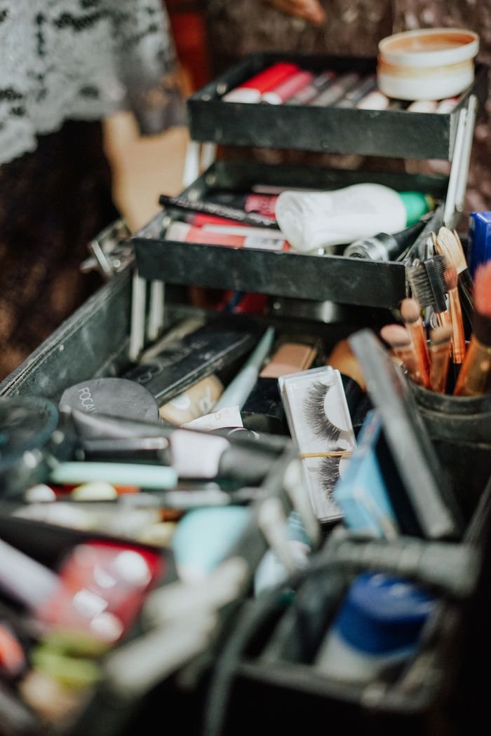 A detailed view of a makeup kit filled with cosmetics, brushes, and beauty tools, ideal for beauty enthusiasts.