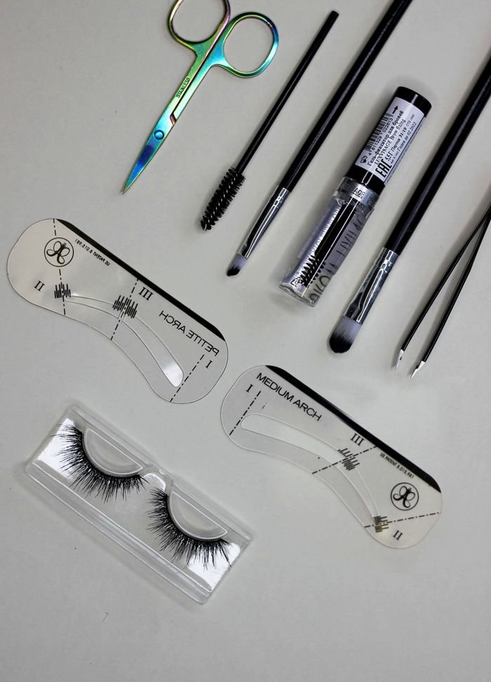 A collection of essential makeup tools for achieving perfectly shaped eyebrows.